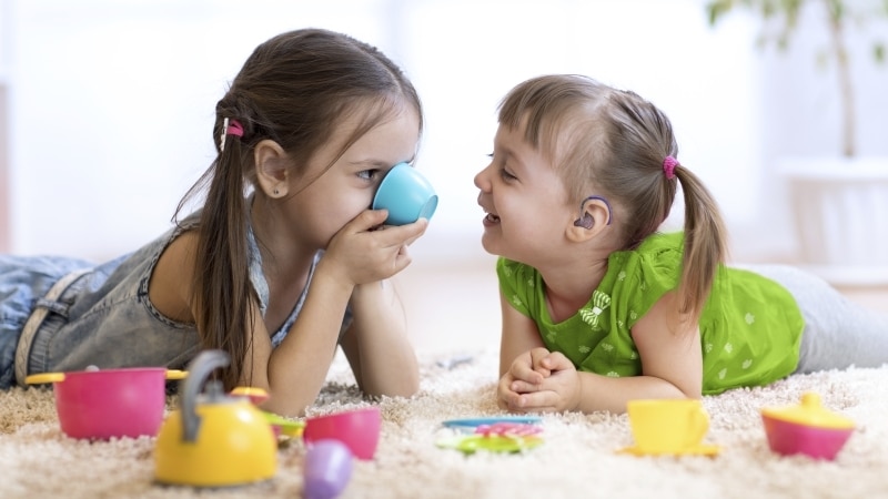 Cute funny children playing with toys at home